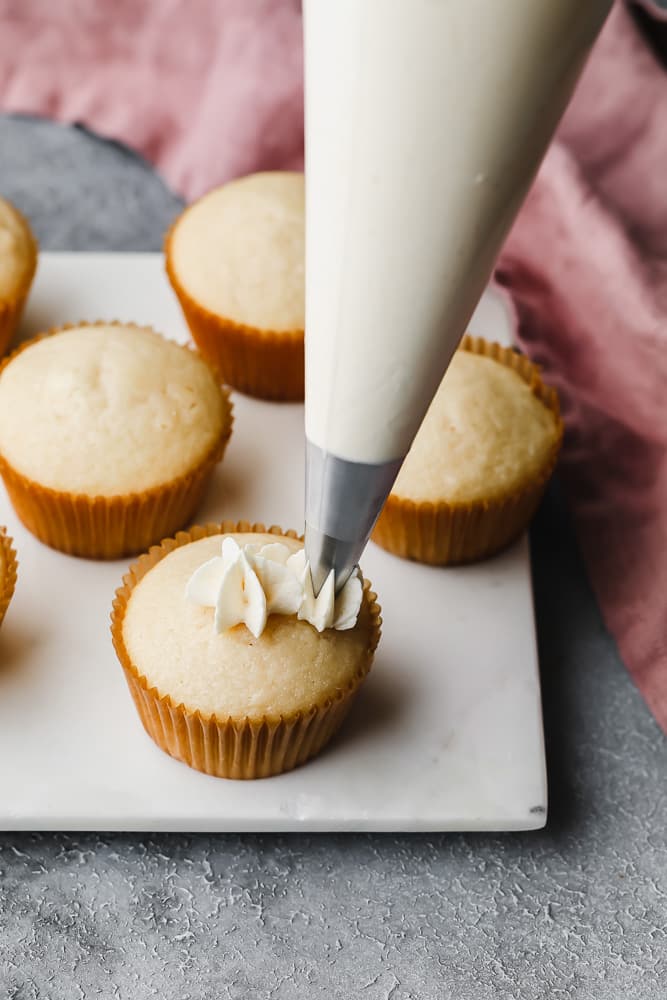 swirly dollops on a cupcake, frosting bag showing how to frost