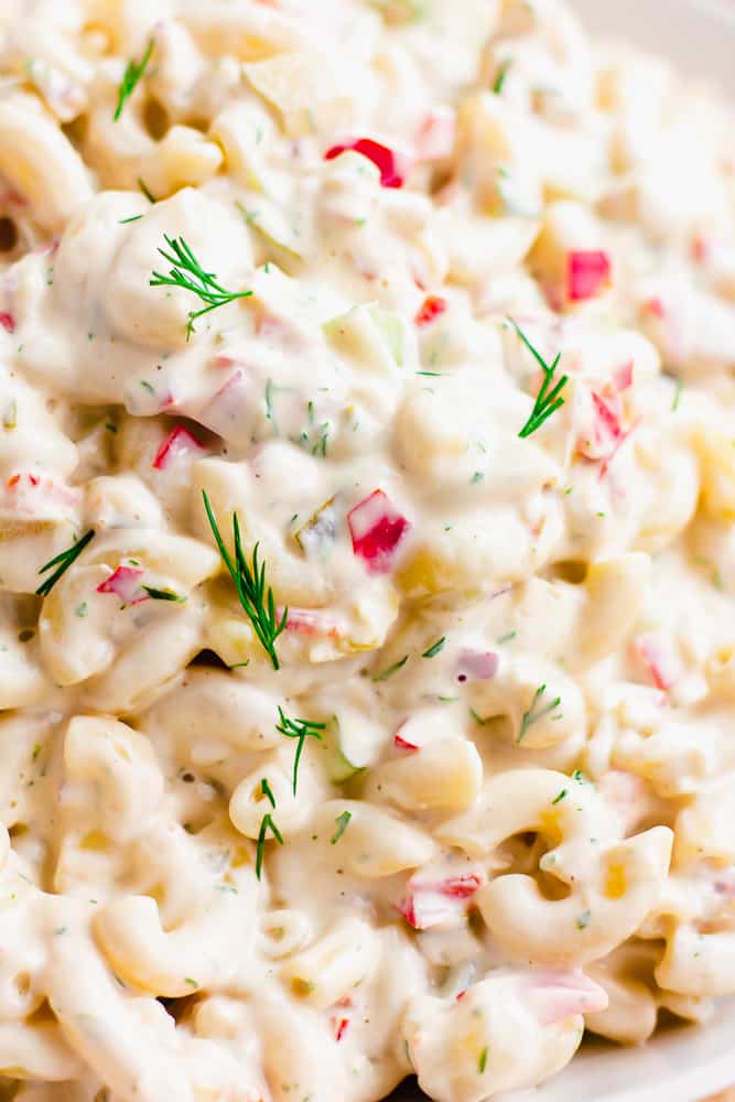 super close up photo of vegan macaroni salad with red peppers, dill and noodles