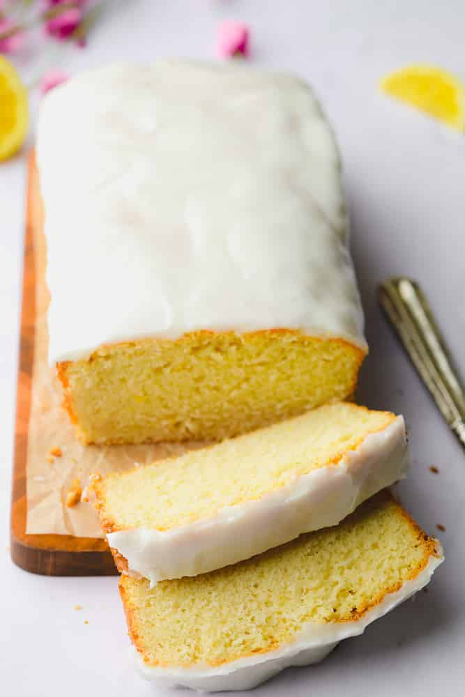 sliced vegan pound cake on a wood board.