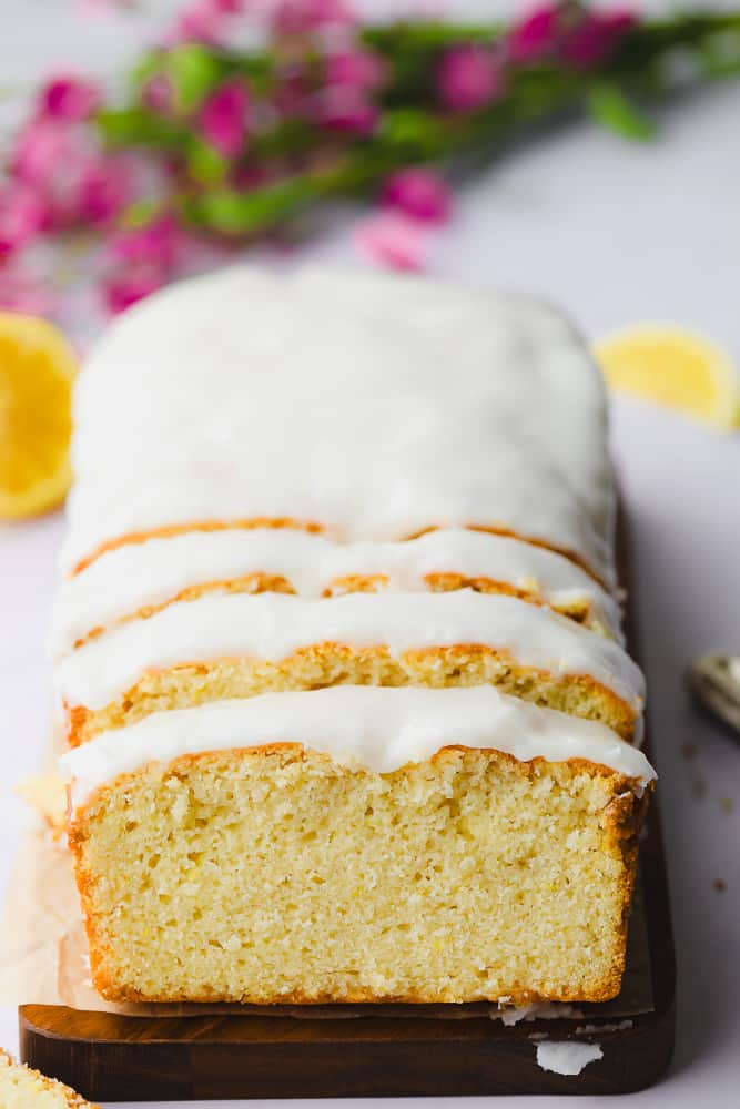 sliced vegan pound cake on a wood board.