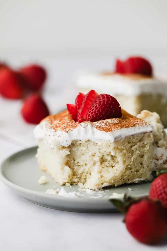 yellow cake with white frosting and strawberries on top