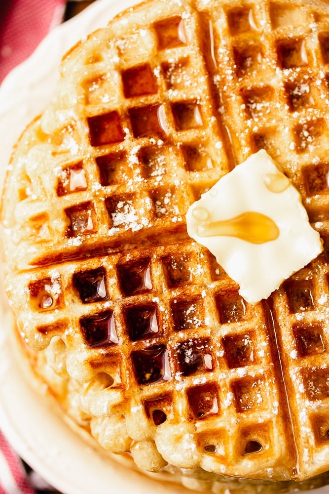 close up of a waffle with butter and syrup on it