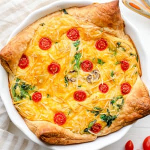 A baked JUST Egg quiche in a white pie plate.