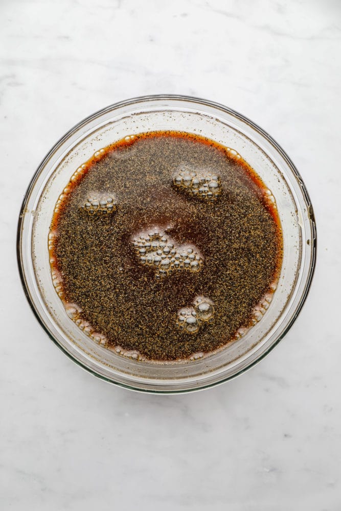 brown sauce with bubbles in a glass bowl