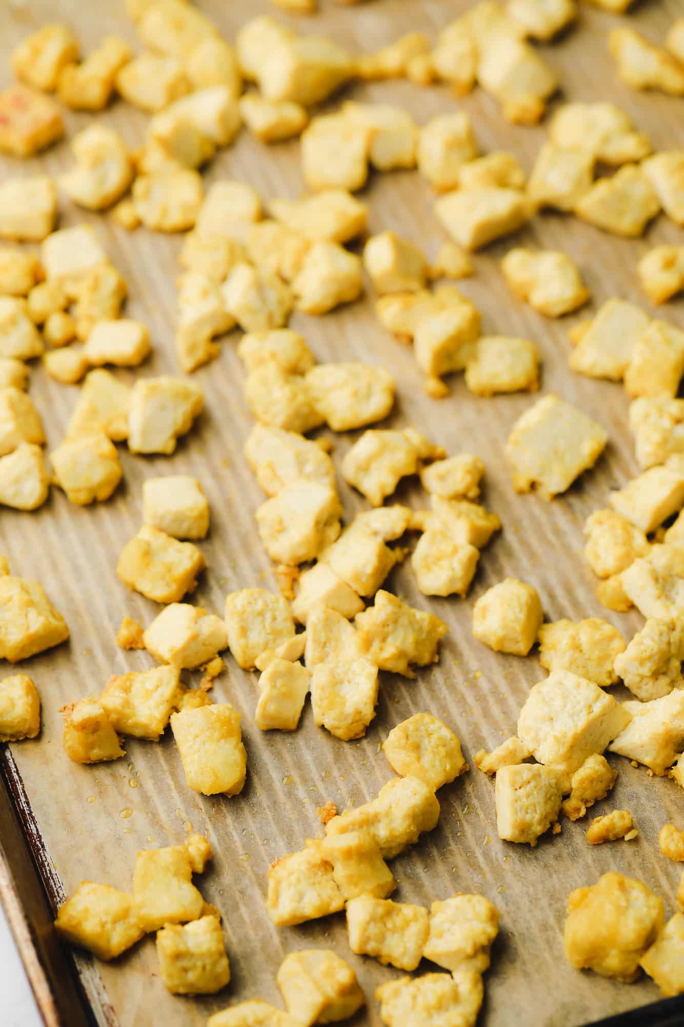 baked tofu cubes on a metal sheet pan.