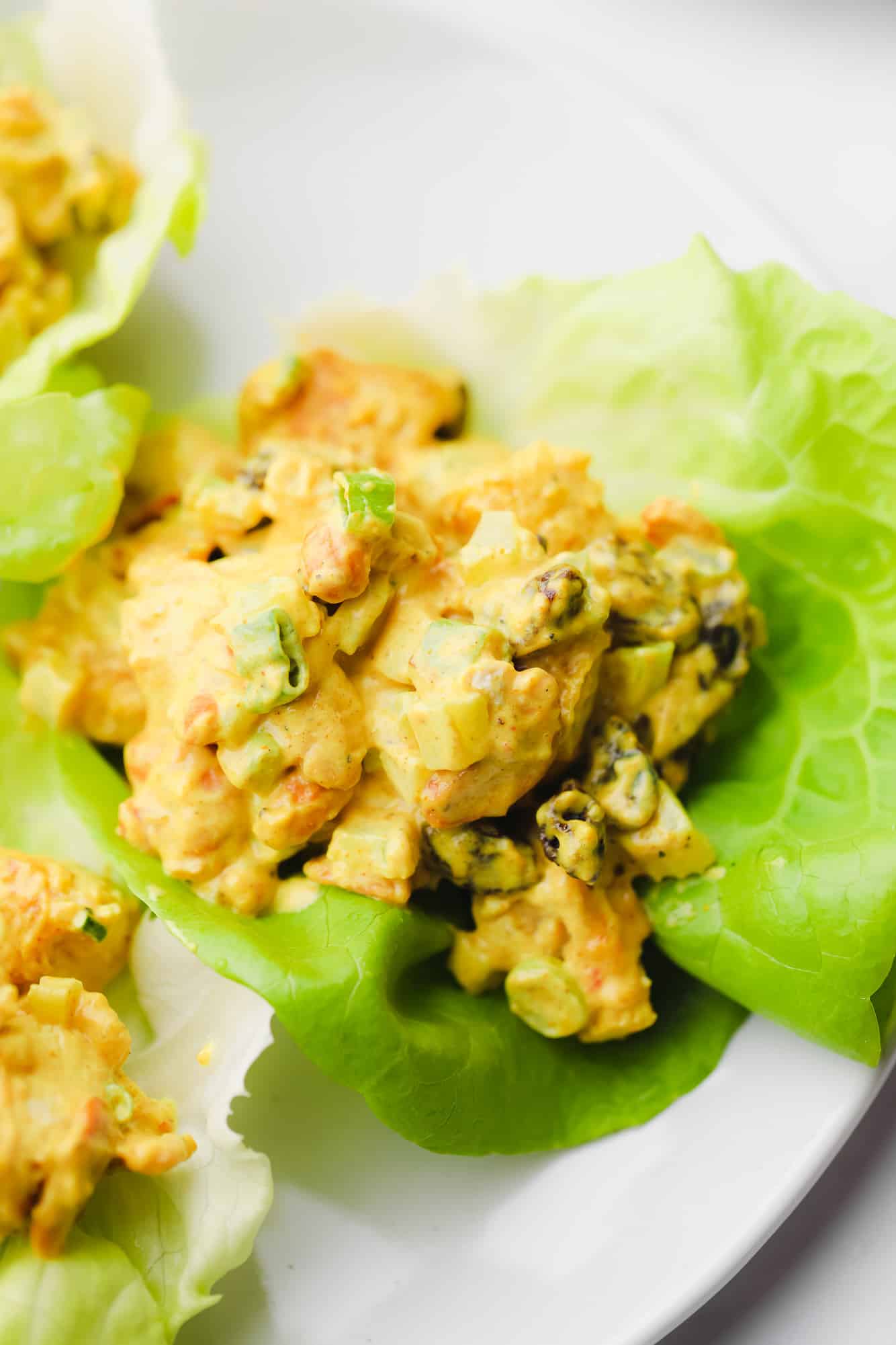 close up on a creamy curry tofu salad in a lettuce cup.