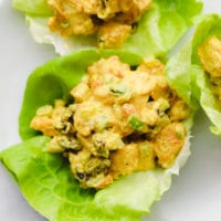 close up on a creamy curry tofu salad in a lettuce cup.