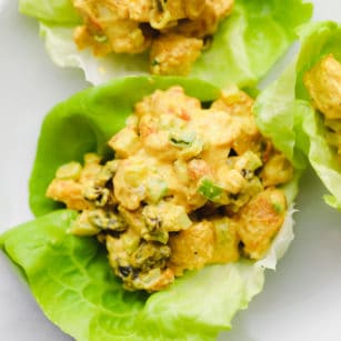 close up on a creamy curry tofu salad in a lettuce cup.