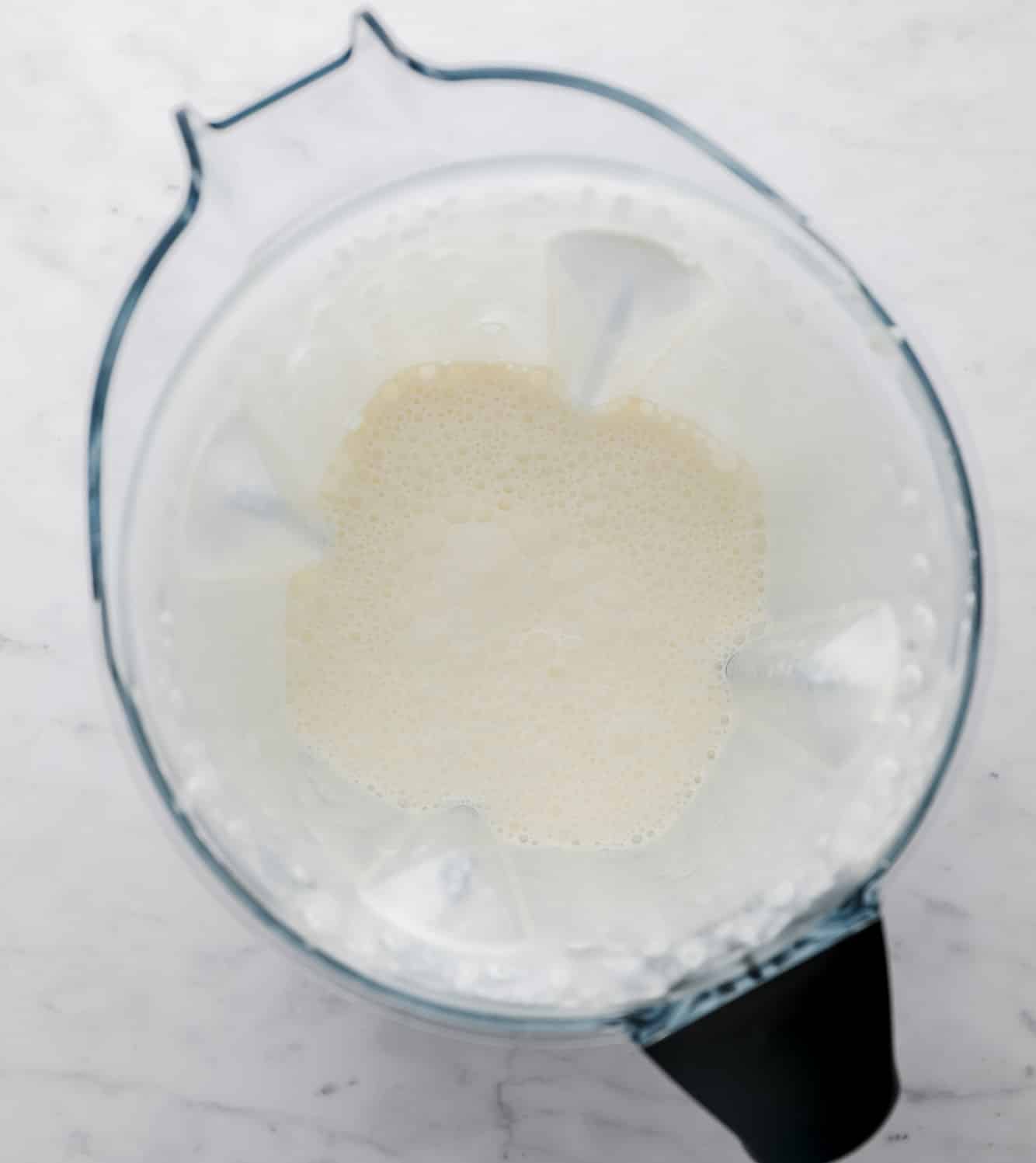 bubbly coconut oil and soy milk in a large blender.