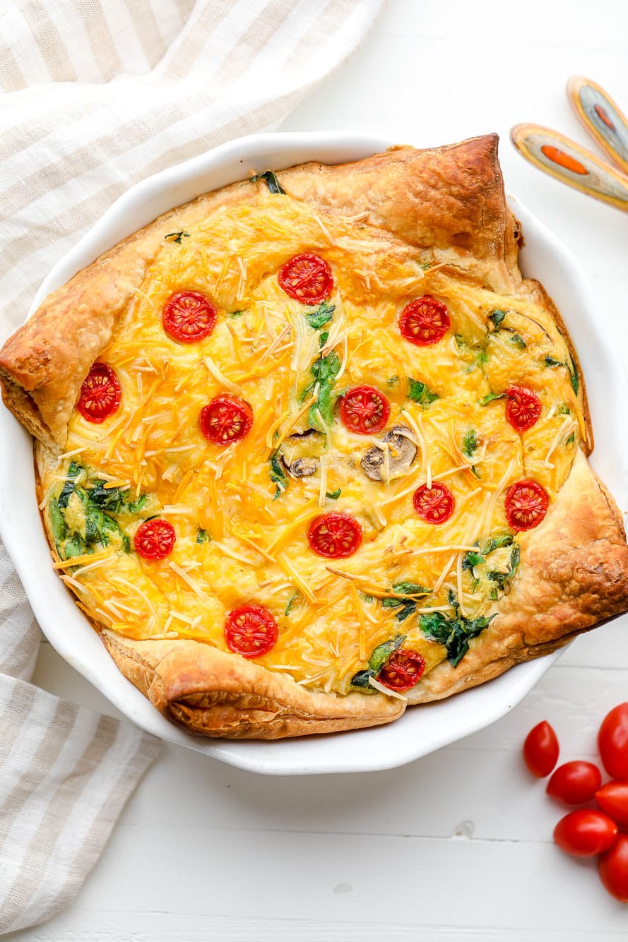 A baked JUST Egg quiche in a white pie plate.