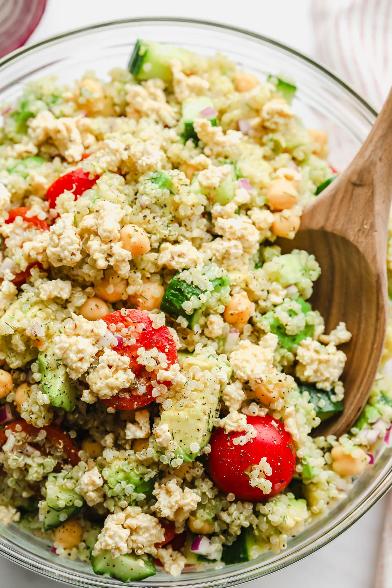 close up on quinoa salad with chickpeas in a large glass bowl.