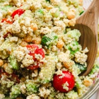 close up on quinoa salad with chickpeas in a large glass bowl.
