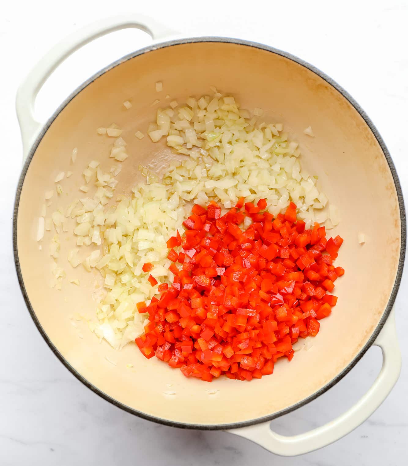 sautéing diced onion and red bell pepper in a large soup pot.