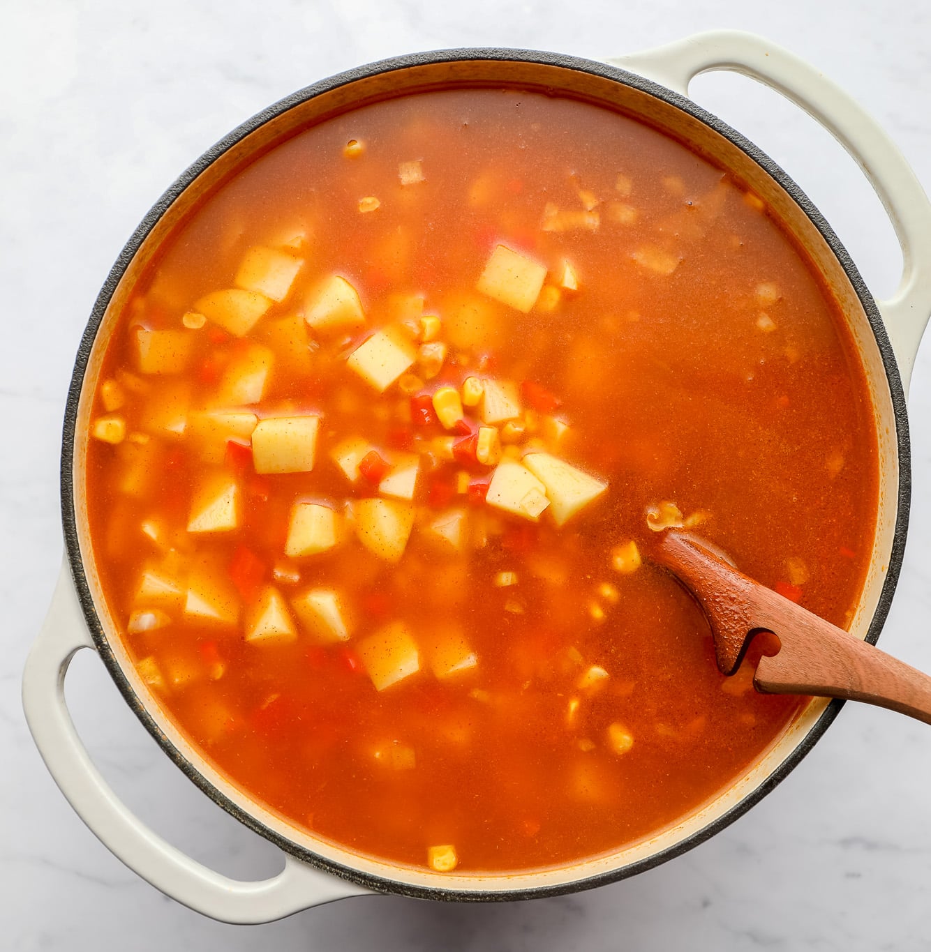 cooking vegan corn chowder in a large soup pot.