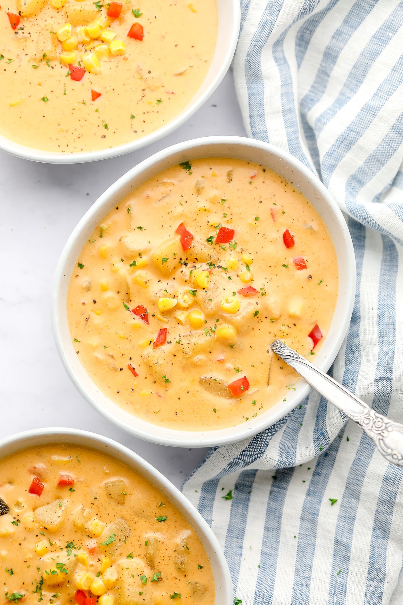 3 bowls of vegan corn chowder next to each other.