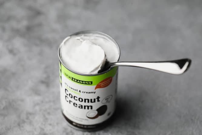 can of coconut cream with a spoon