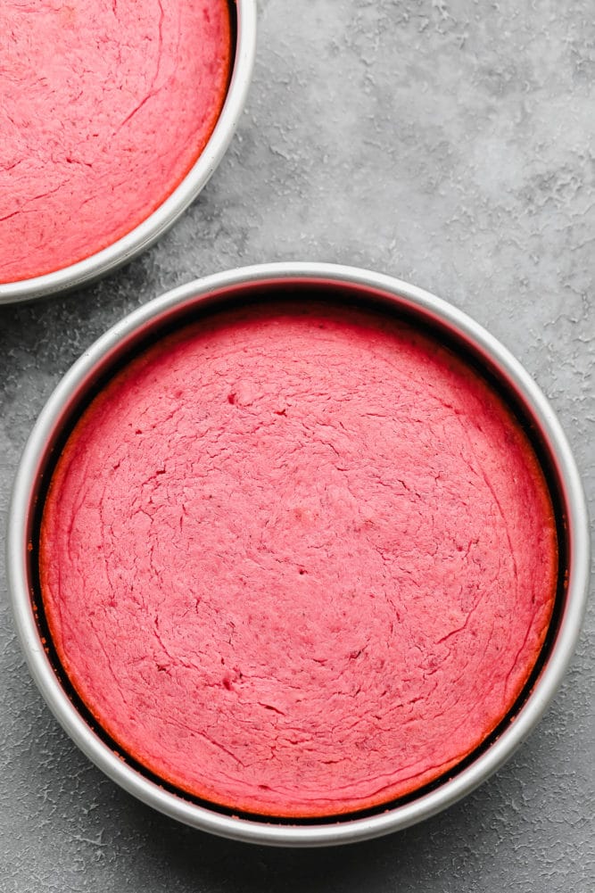 cooked pink cakes in silver pans