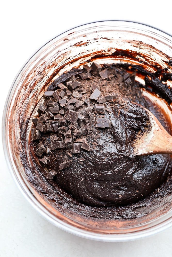 brownie dough with chocolate chunks in glass bowl