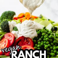 pinterest image of pouring vegan ranch dressing over a large green salad.