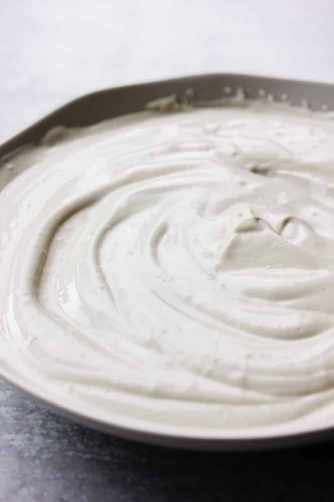 swirly bowl of white cream, grey background