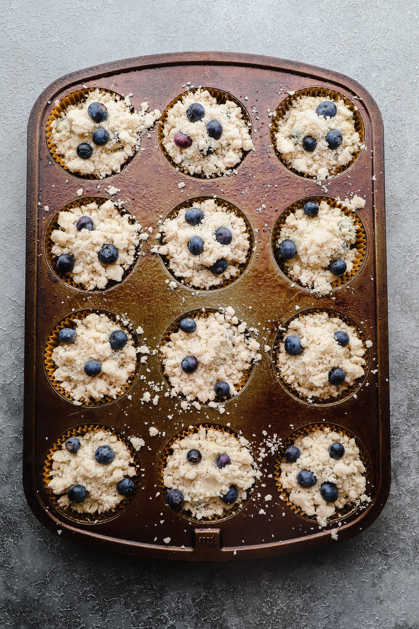 unbaked gluten free blueberry muffins in a muffin pan.