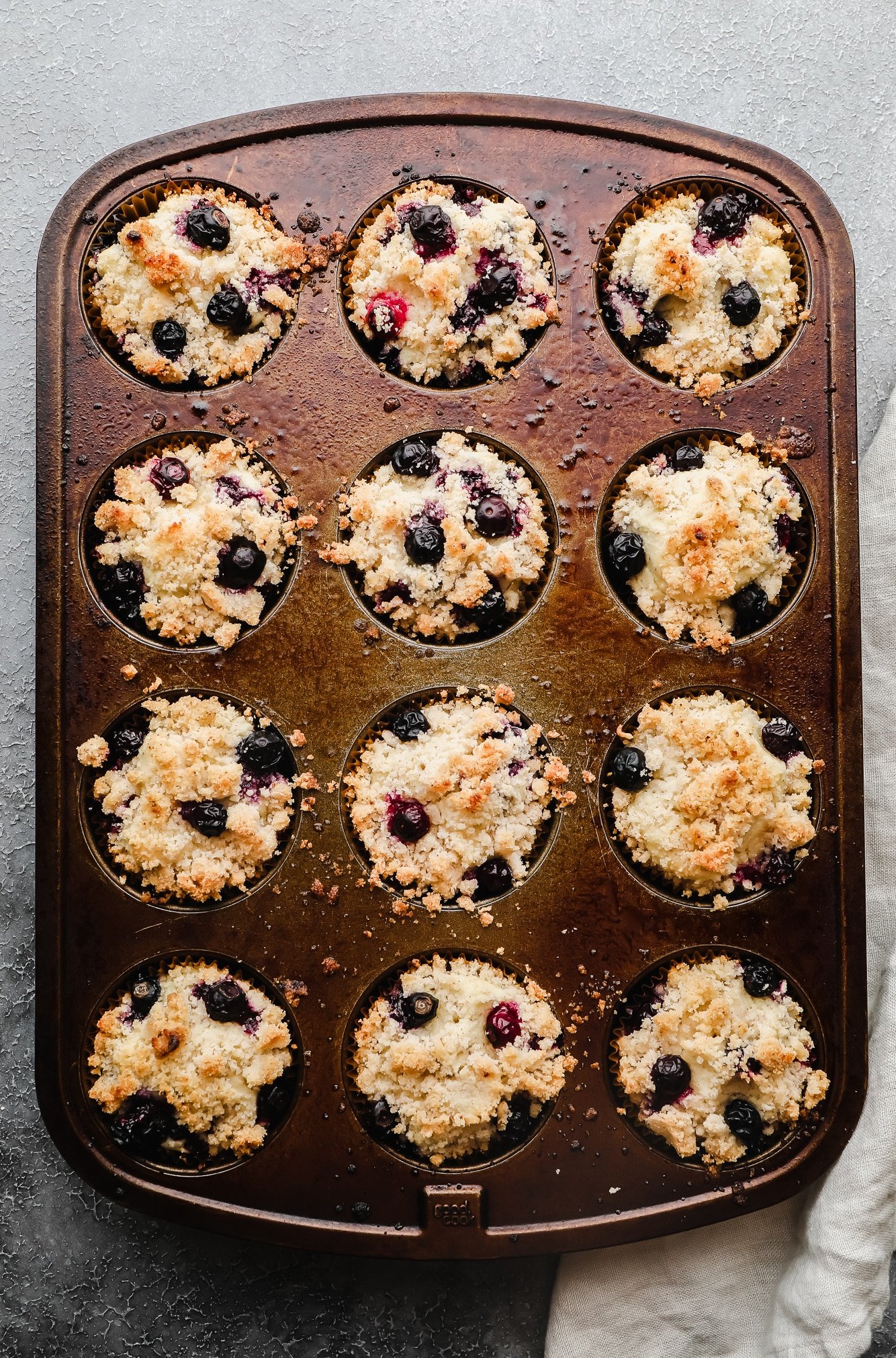 baked gluten free blueberry muffins in a muffin pan.