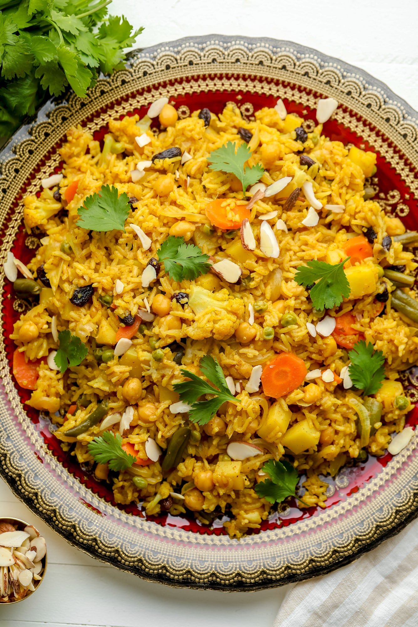 vegan biryani on a large decorative plate.