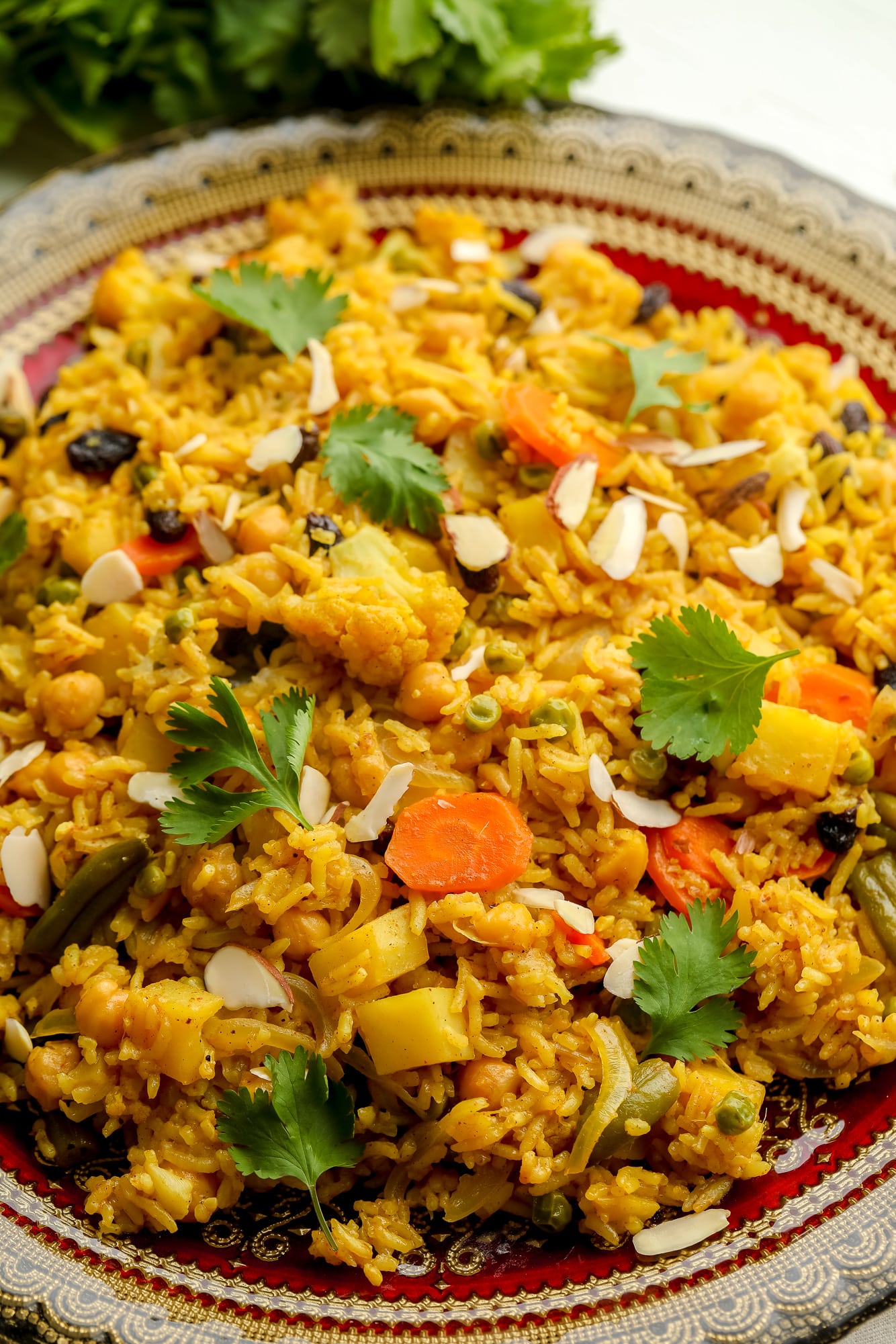 close up on vegan biryani on a large decorative plate.