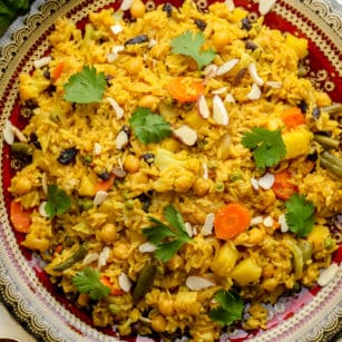 close up on vegan biryani on a large decorative plate.