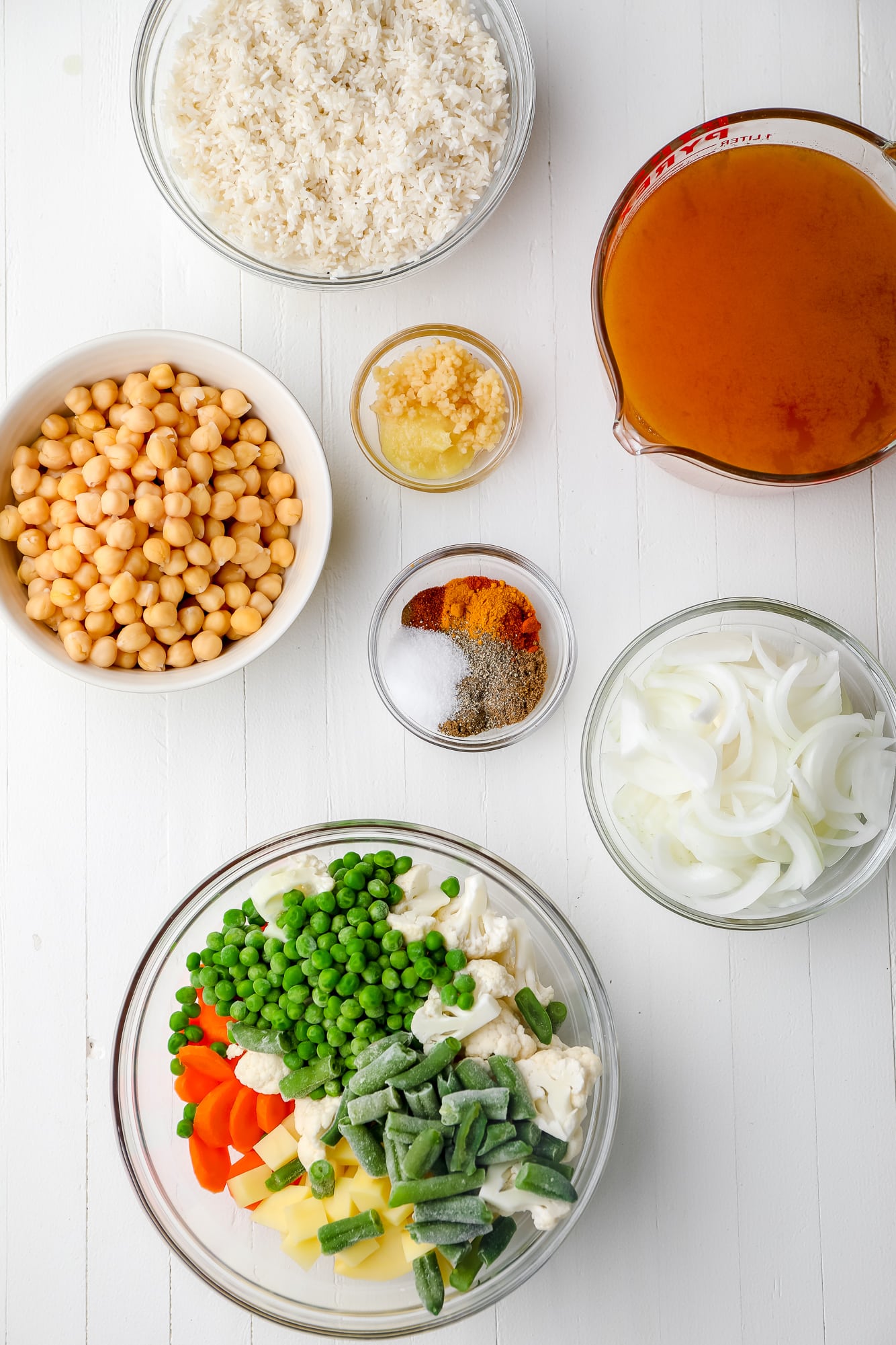 ingredients for vegan biryani in individual glass bowls.