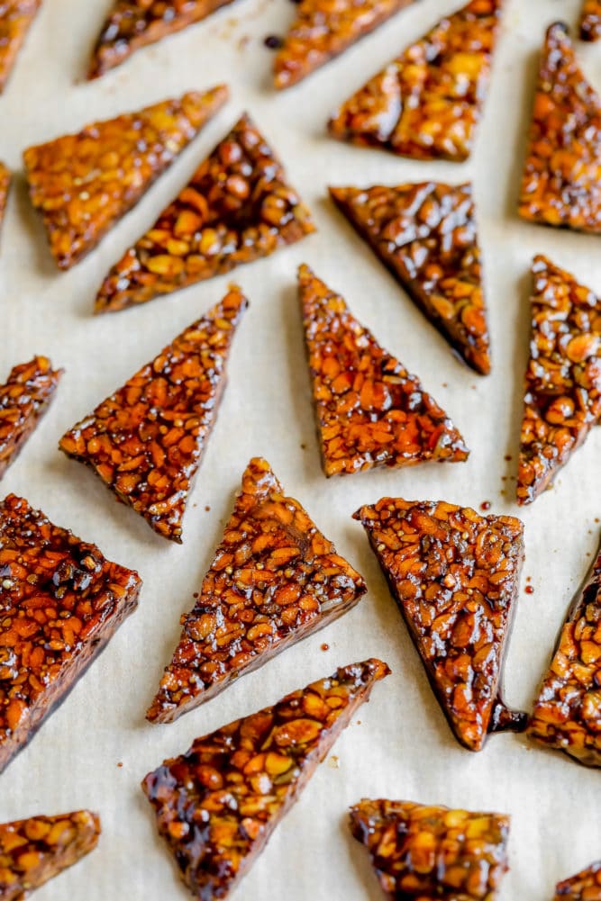 uncooked tempeh in sauce on parchment