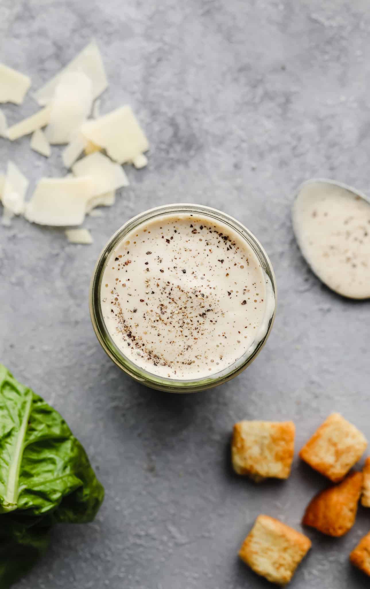 overhead view of vegan caesar dressing in a glass jar.