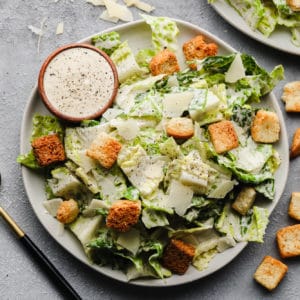 square image of a plate of green salad with croutons and cheese