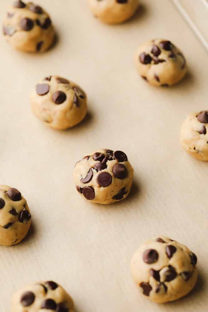 cookie dough balls ready to be baked on baking pan