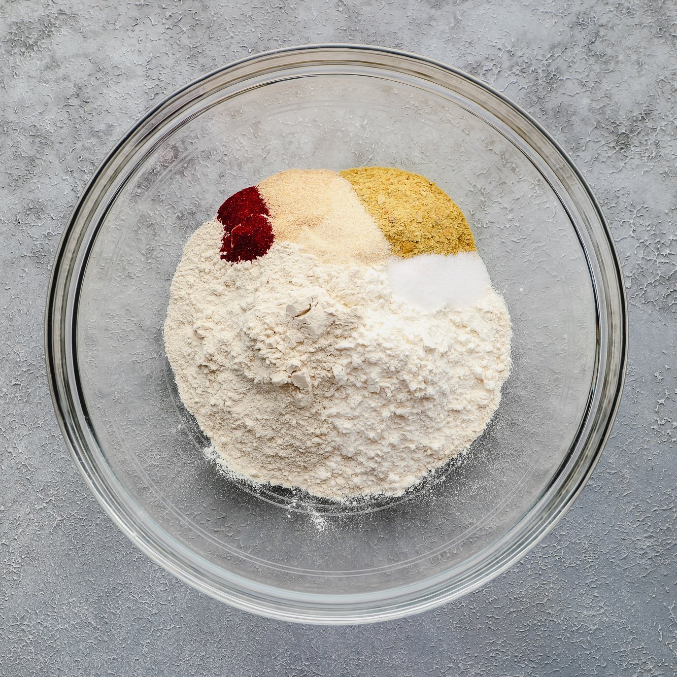 dry ingredients for vegan wings mixed together in a glass bowl.