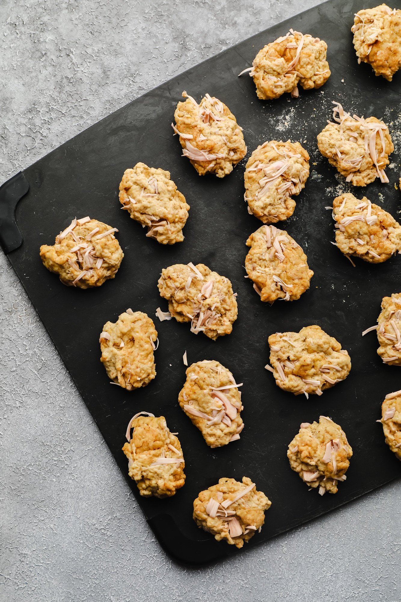 raw vegan wing pieces on a black board.