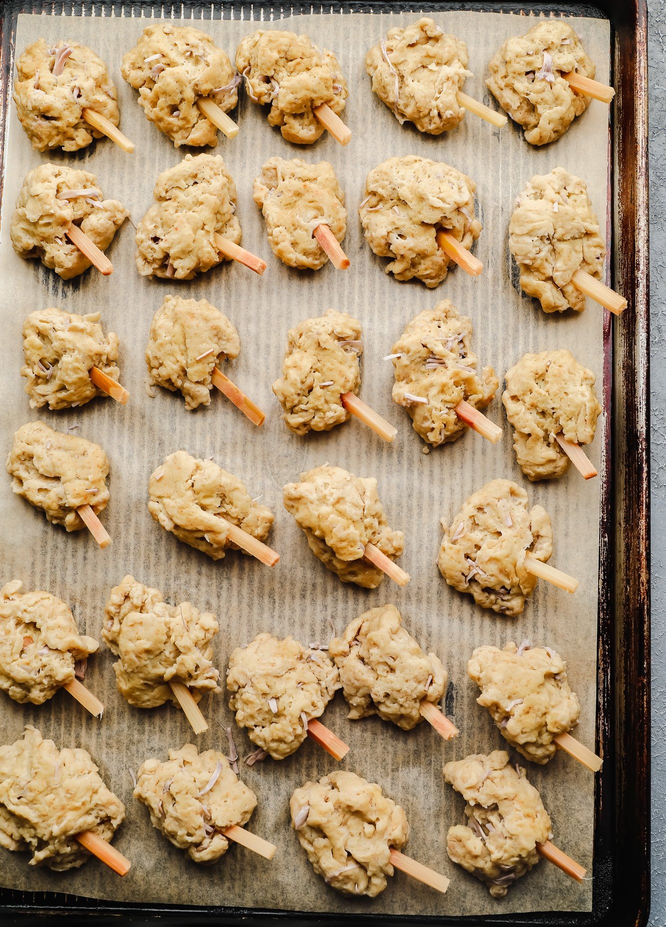 unbaked vegan wings on a parchment lined baking sheet.