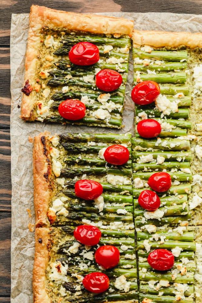 sliced asparagus tart with whole cherry tomatoes, baked