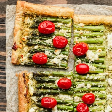 square image of puff pastry with asparagus, feta and tomatoes