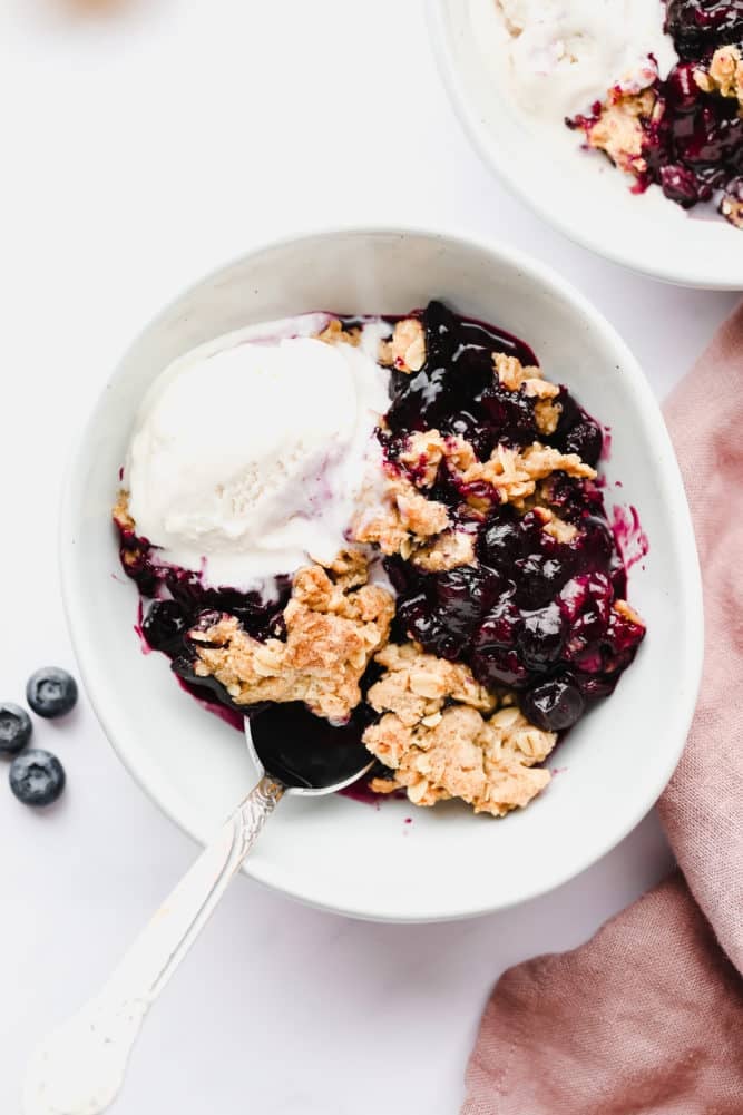 bowl of ice cream and blueberry oat mixture