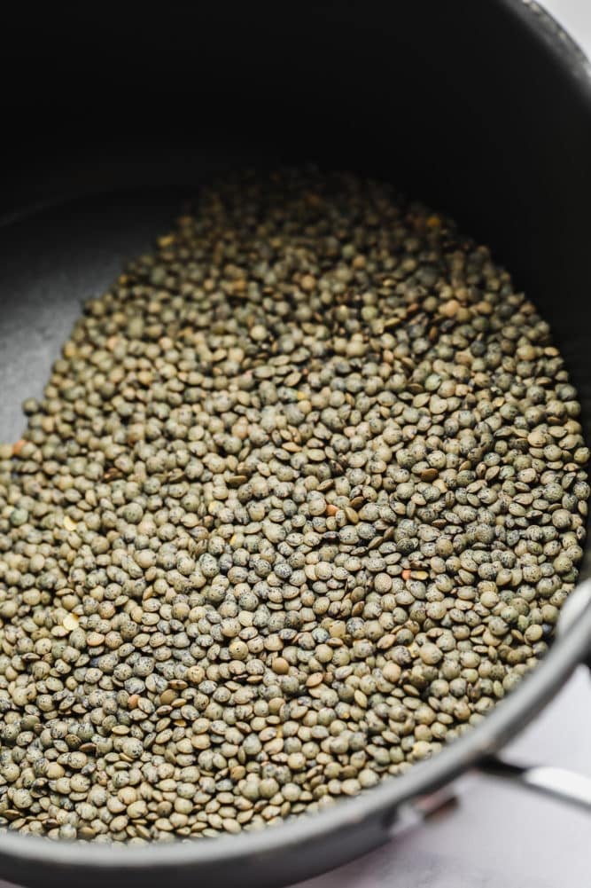 dried green lentils in a pot, no water