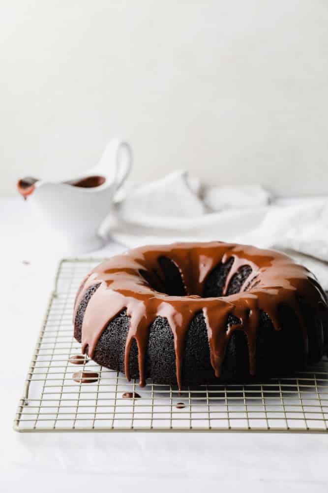 vegan bundt cake with chocolate icing, white background