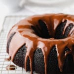 chocolate bundt cake on rack with white background