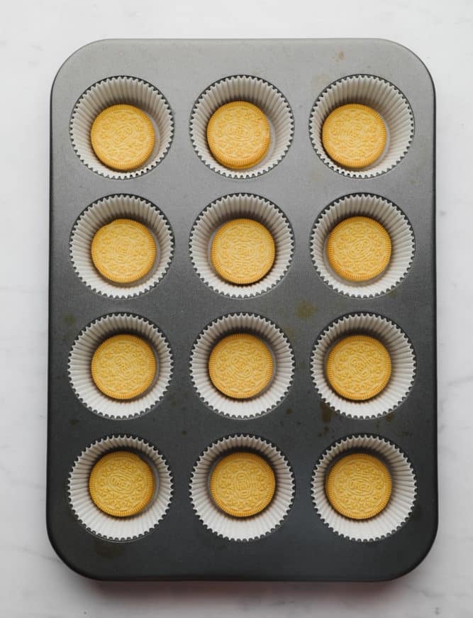 muffin pan with yellow oreo in each cup