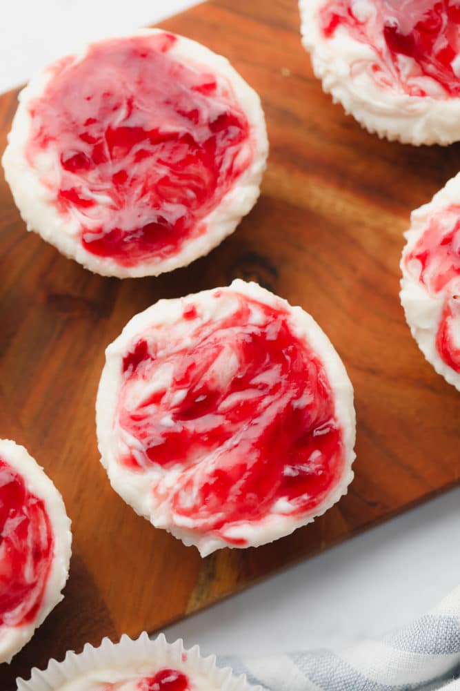 raspberry jam swirl on cheesecake bites on cutting board
