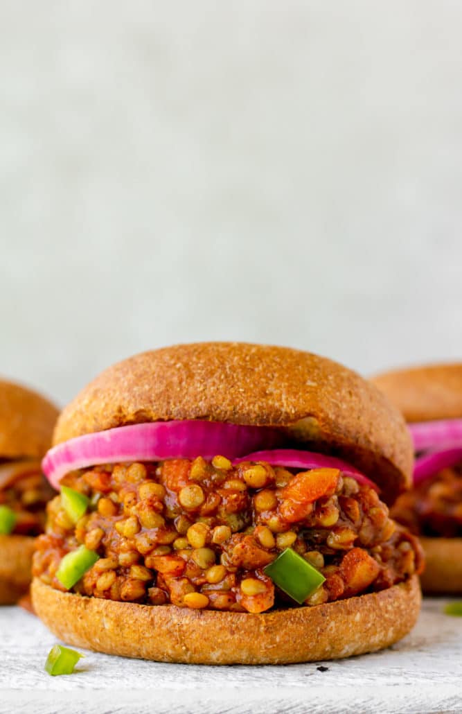 bun with lentil vegan sloppy joes mixture and red onion