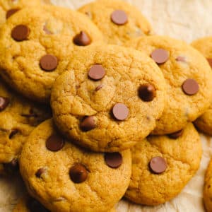 close up on a pile of pumpkin chocolate chip cookies.