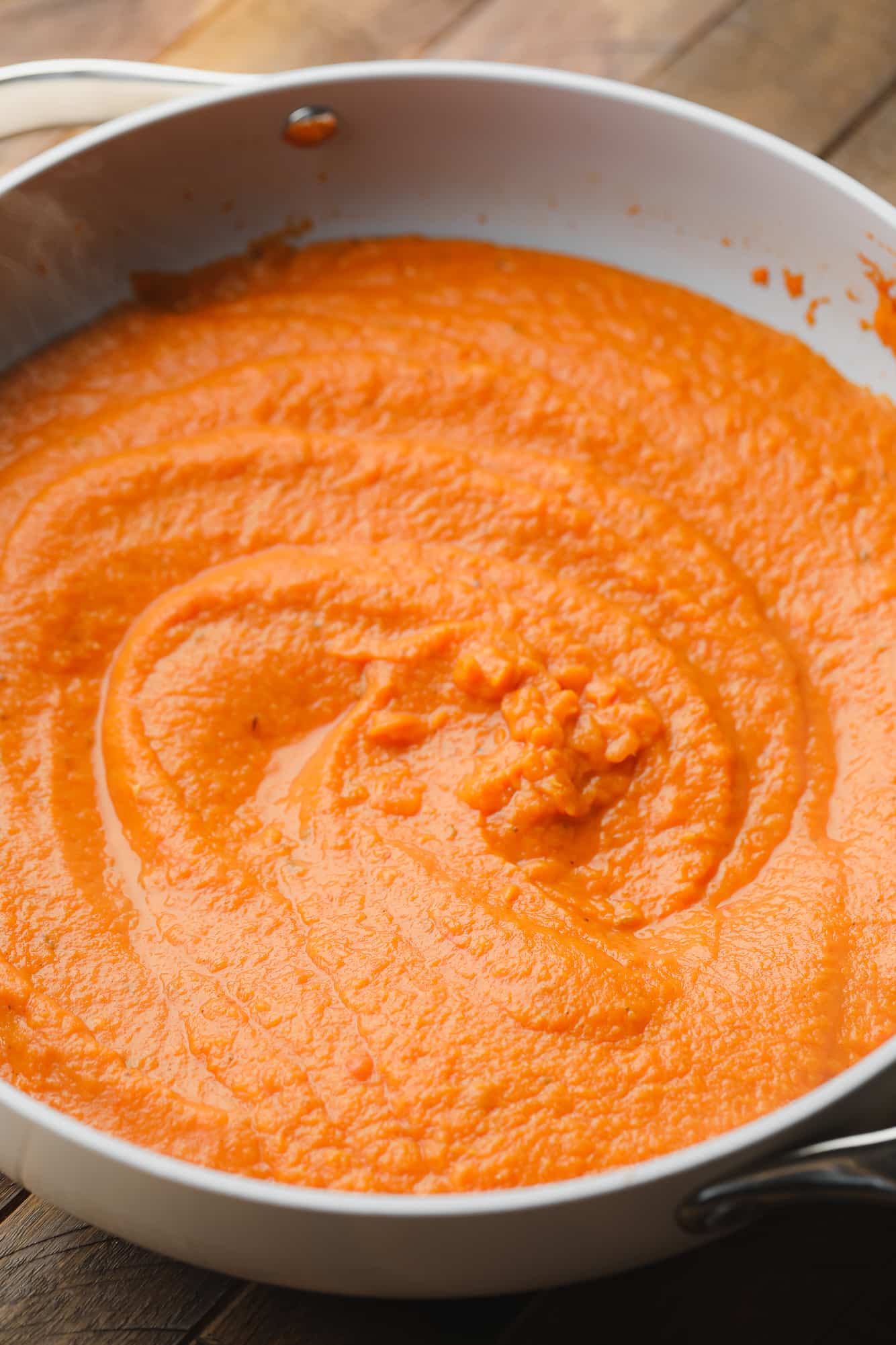 close up on pumpkin pasta sauce in a large skillet.