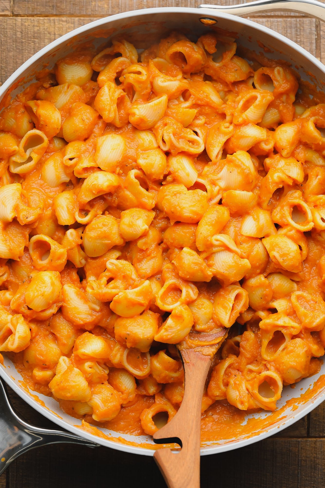 pasta noodles covered in pumpkin pasta sauce in a large skillet.