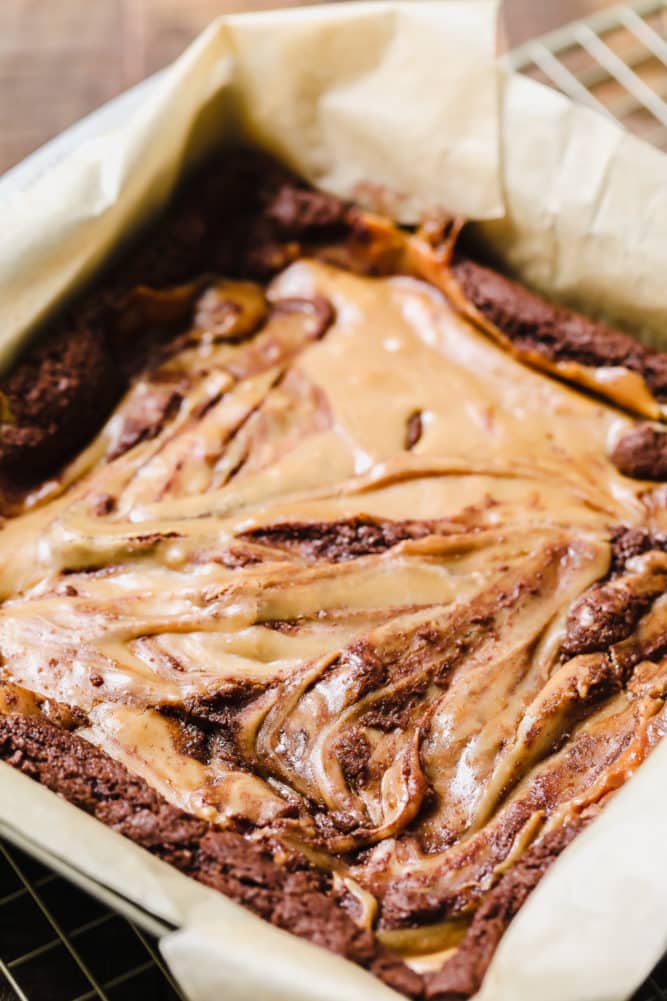 brownie pan swirled with caramel sauce on top.